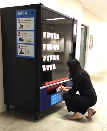 image of a vending machine machine with free naloxone kits inside